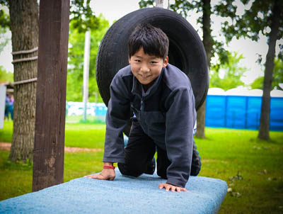 Andrew Pak, Southern New England Conference is all smiles now that he completed his obstacle course activity.