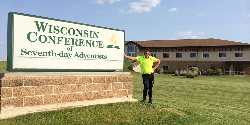Scott Christiansen in front of the Wisconsin Conference offices, which the ride route happened to pass (Photo credit Beniah Christiansen)