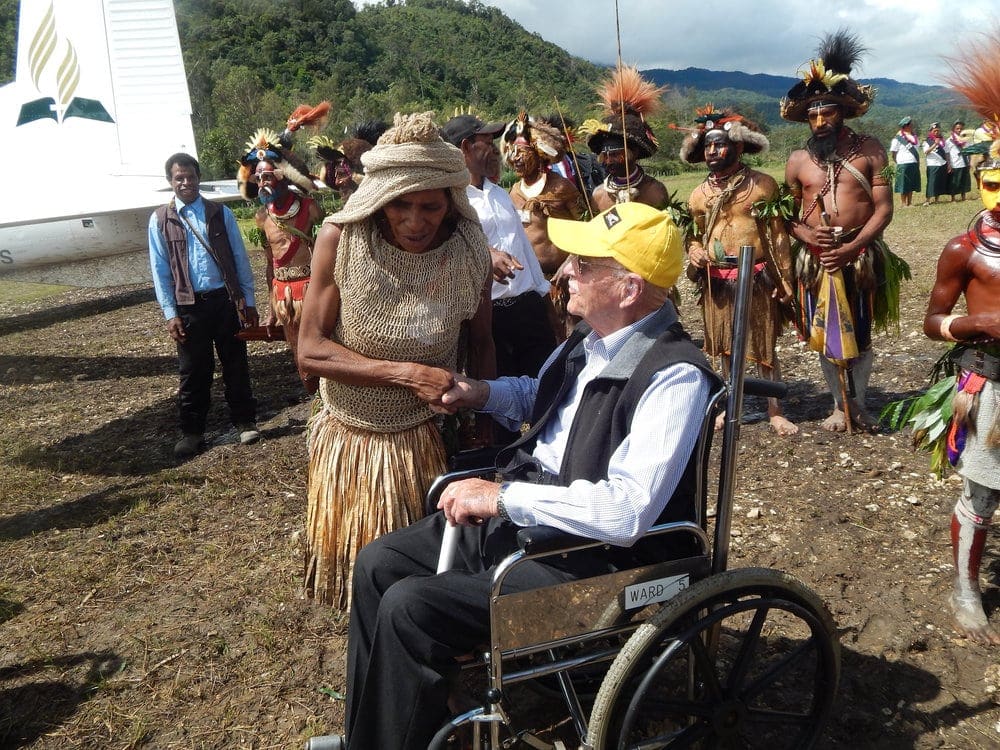 Barnard being greeted by people wearing traditional garb at the 50th-anniversary event in Goroka, Papua New Guinea, last year. Photo: Adventist Record