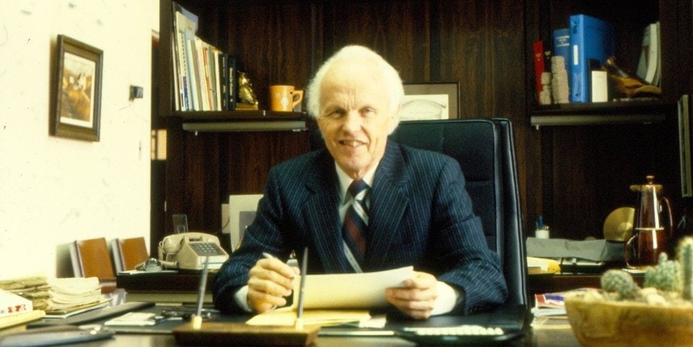 Delmer Holbrook sitting at his desk at Home Study Institute. (Charlotte Conway)