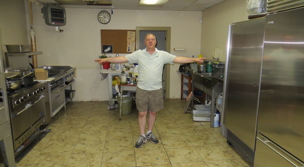 Head elder Don Baker showing equipment donated by actor Dustin Hoffman in the kitchen of the Pocono Grace Church. Photo: Ray Hartwell