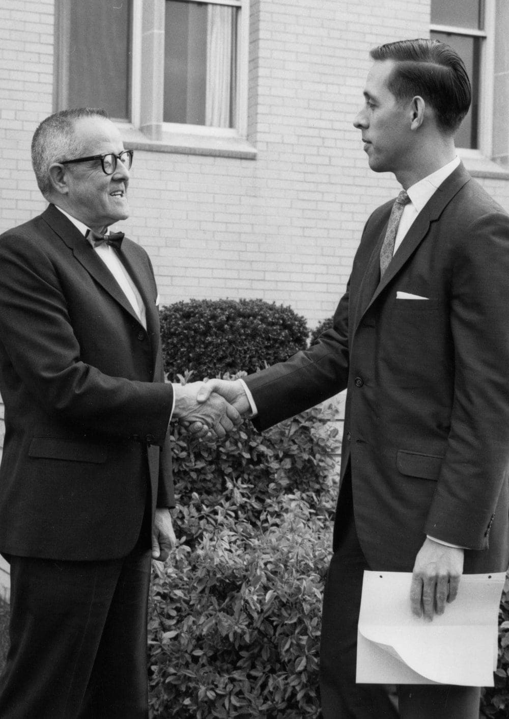 <strong>ALMA MATER:</strong> Lee Boothby, right, shaking hands with evangelist Fordyce W. Detamore in 1967 at his alma mater Andrews University, where he served as a member of the board of trustees. Credit: Center for Adventist Research Image Database