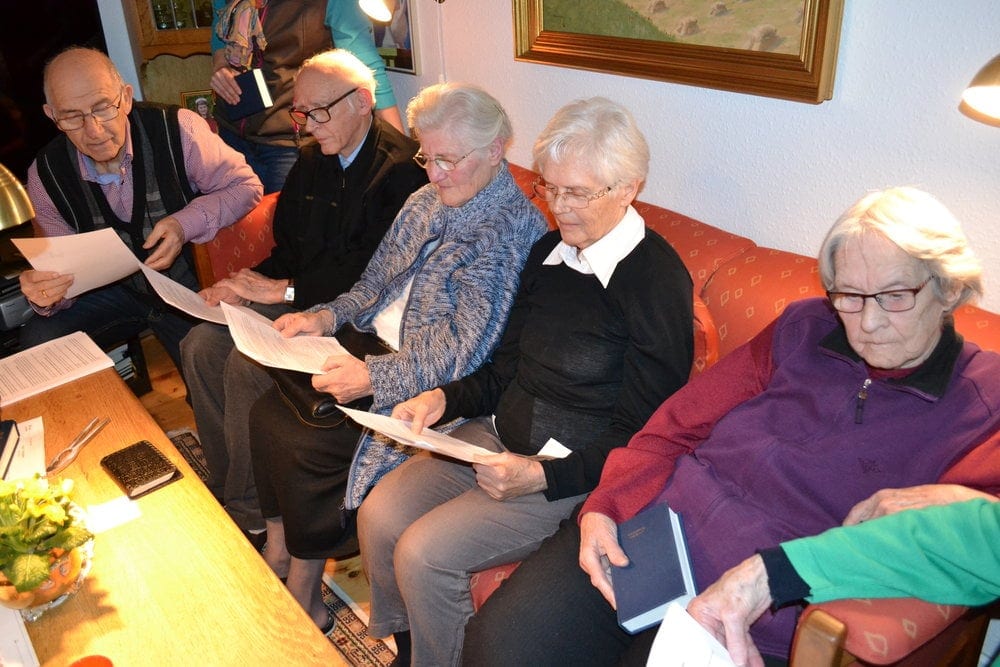 Church members praying in a private home in Denmark. 