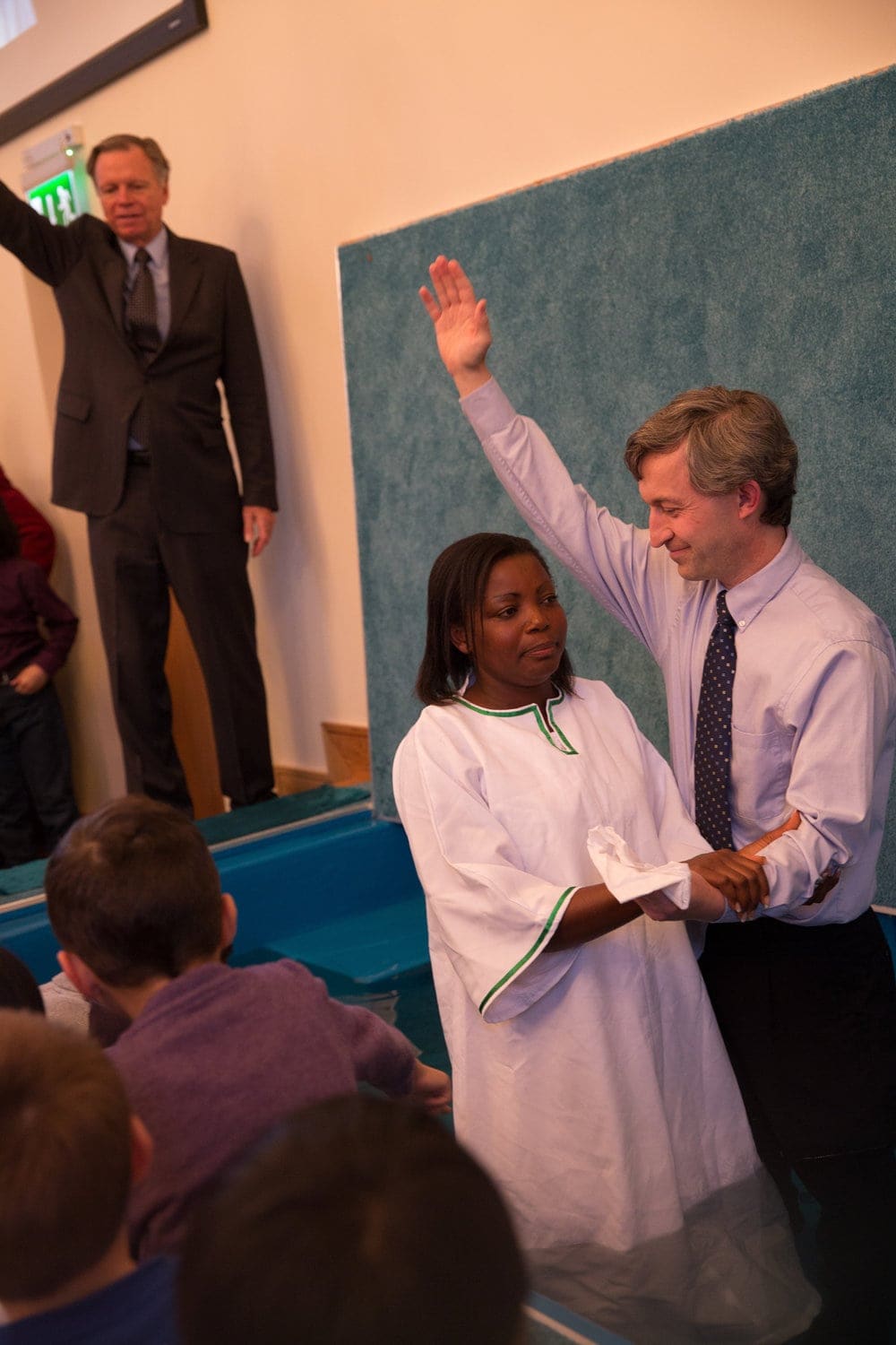 Pastor Gavin Anthony baptizing a woman as Mark Finley watches at the September meetings. Photo: Denzil McNeilus