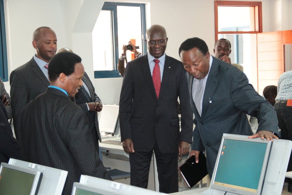 Prime Minister Anastase Murekesi, center, touring a computer lab in the new facility. University chancellor Blasious Ruguri is standing in the foreground to the left. Photo: Claude Richli
