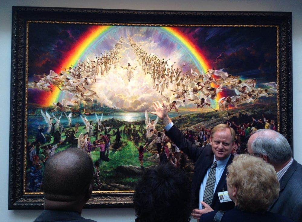 Artist Nathan Greene discussing a painting at the "Eden to Eden" exhibit in the artium. Photo: Andrew McChesney / AR