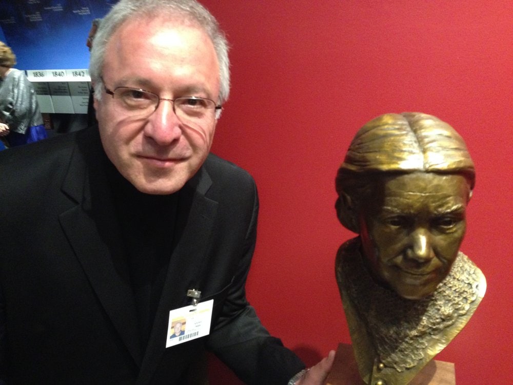 Sculptor Victor Issa posing with his bust of Ellen G. White in the new visitor center. Photo: Andrew McChesney / AR