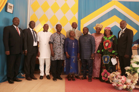 Church Officials with the two College Adhoc staff at the middle large
